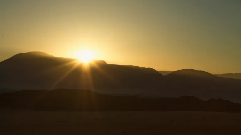 The sun setting over a mountain range.
