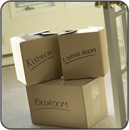 Moving boxes labeled with room names